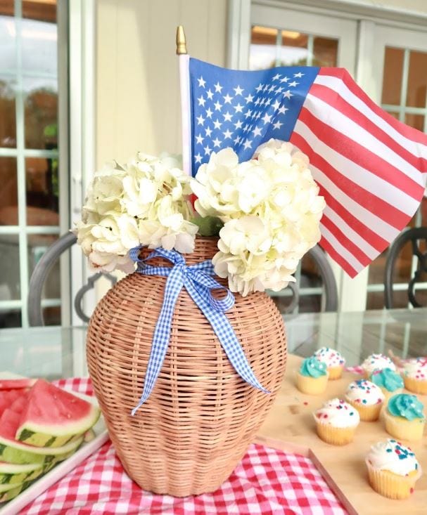 Alexa Fraser with Matt celebrating patriotic event with flowers, flag, and cupcakes.